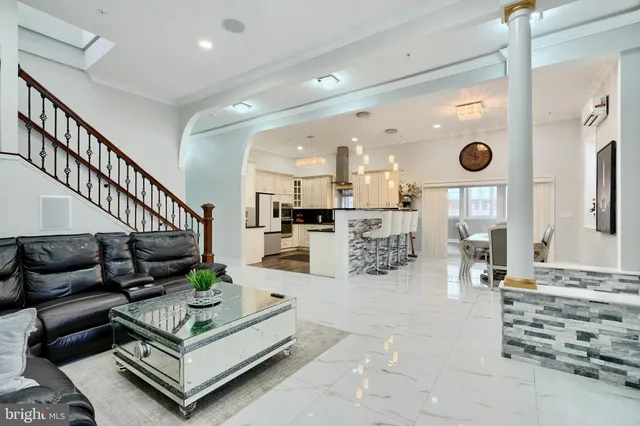 a living room with furniture and stairs