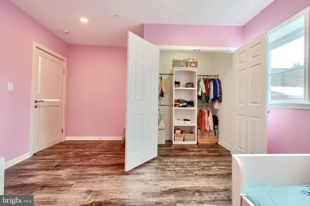 a bathroom with a granite countertop sink vanity and mirror