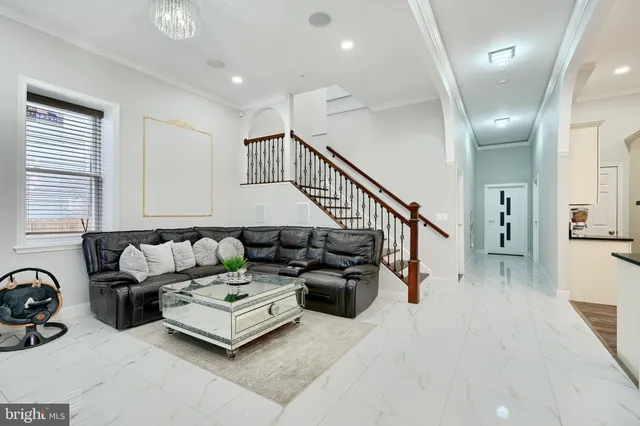 a dining room with furniture and a large window