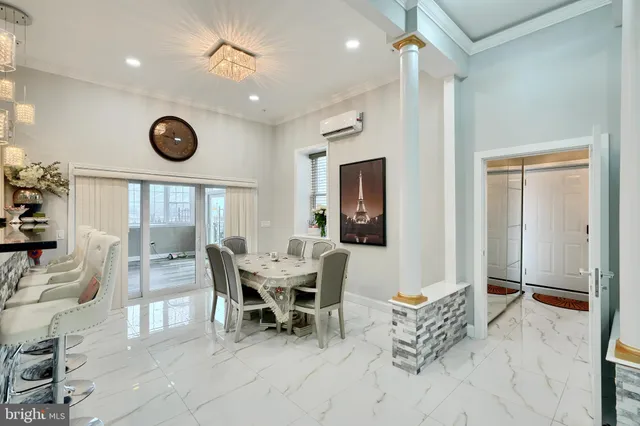 a view of a dining room with furniture and a large window