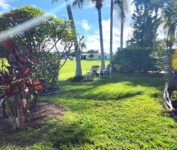 a view of a backyard with swimming pool