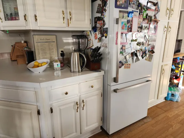 a white refrigerator freezer sitting inside of a kitchen