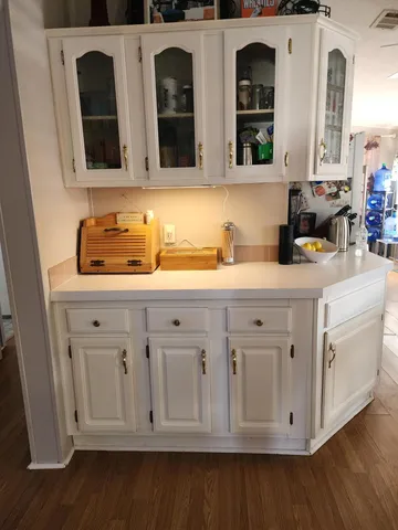 a kitchen with stainless steel appliances granite countertop white cabinets a sink and dishwasher