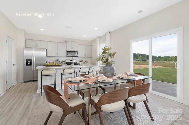 a dining room with furniture and a floor to ceiling window