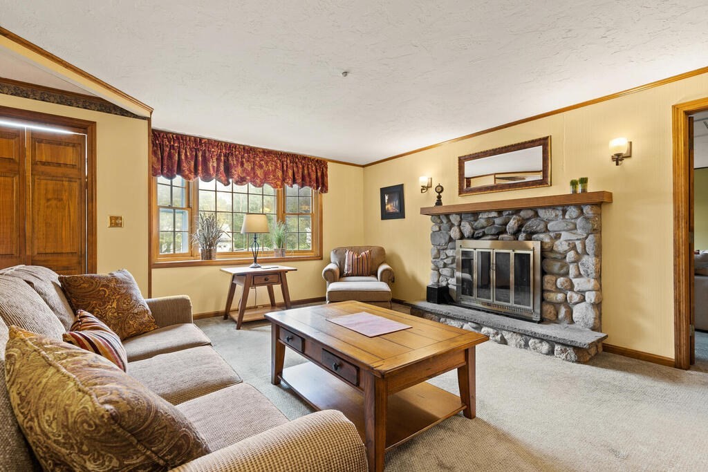 1 Robbin Road Canton, MA 02021 - Photo 13 of 40 a living room with furniture a flat screen tv and a fireplace