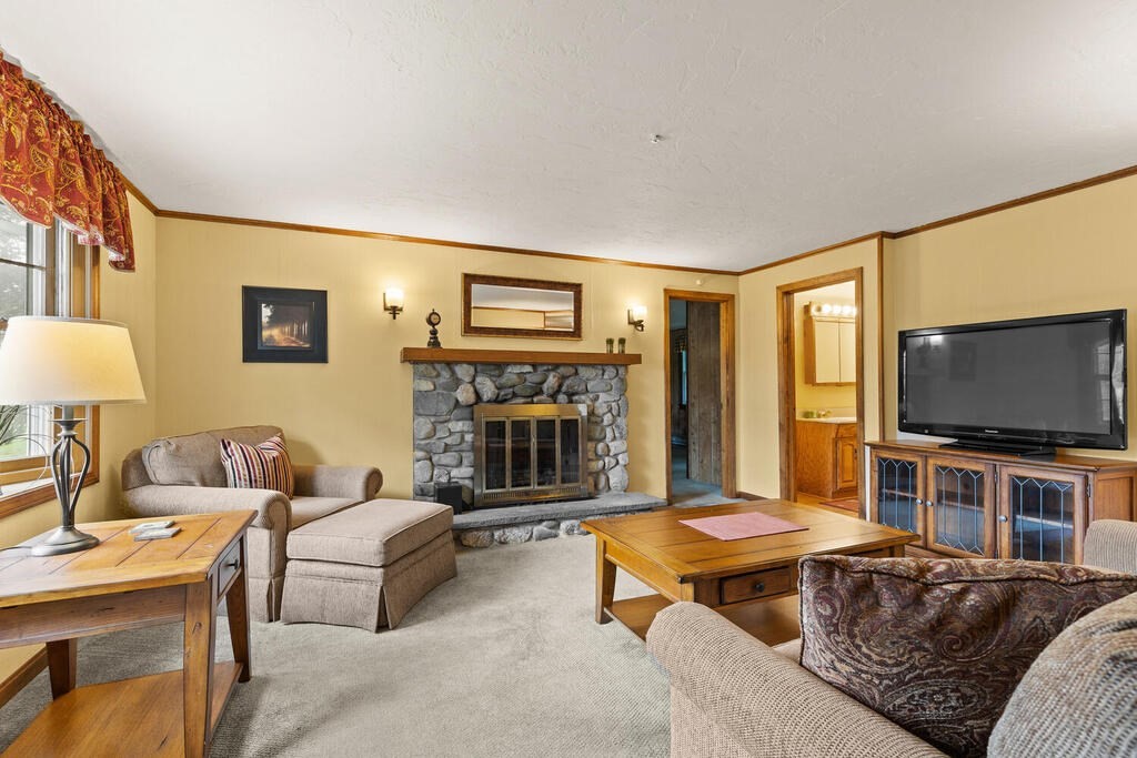 1 Robbin Road Canton, MA 02021 - Photo 15 of 40 a living room with furniture a flat screen tv and floor to ceiling window