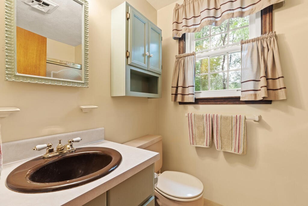 1 Robbin Road Canton, MA 02021 - Photo 35 of 40 a bathroom with a sink a toilet and a mirror