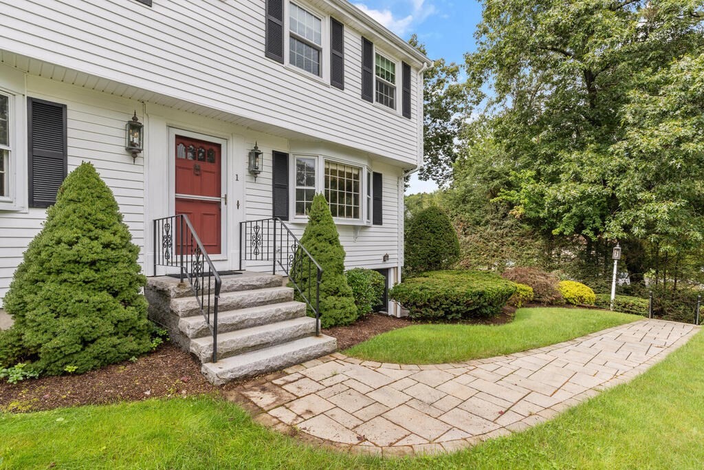 1 Robbin Road Canton, MA 02021 - Photo 5 of 40 a front view of a house with a garden