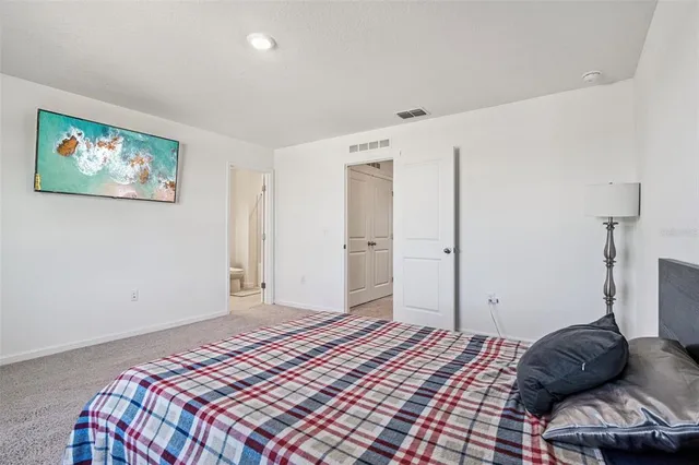 a bedroom with a bed and a couch