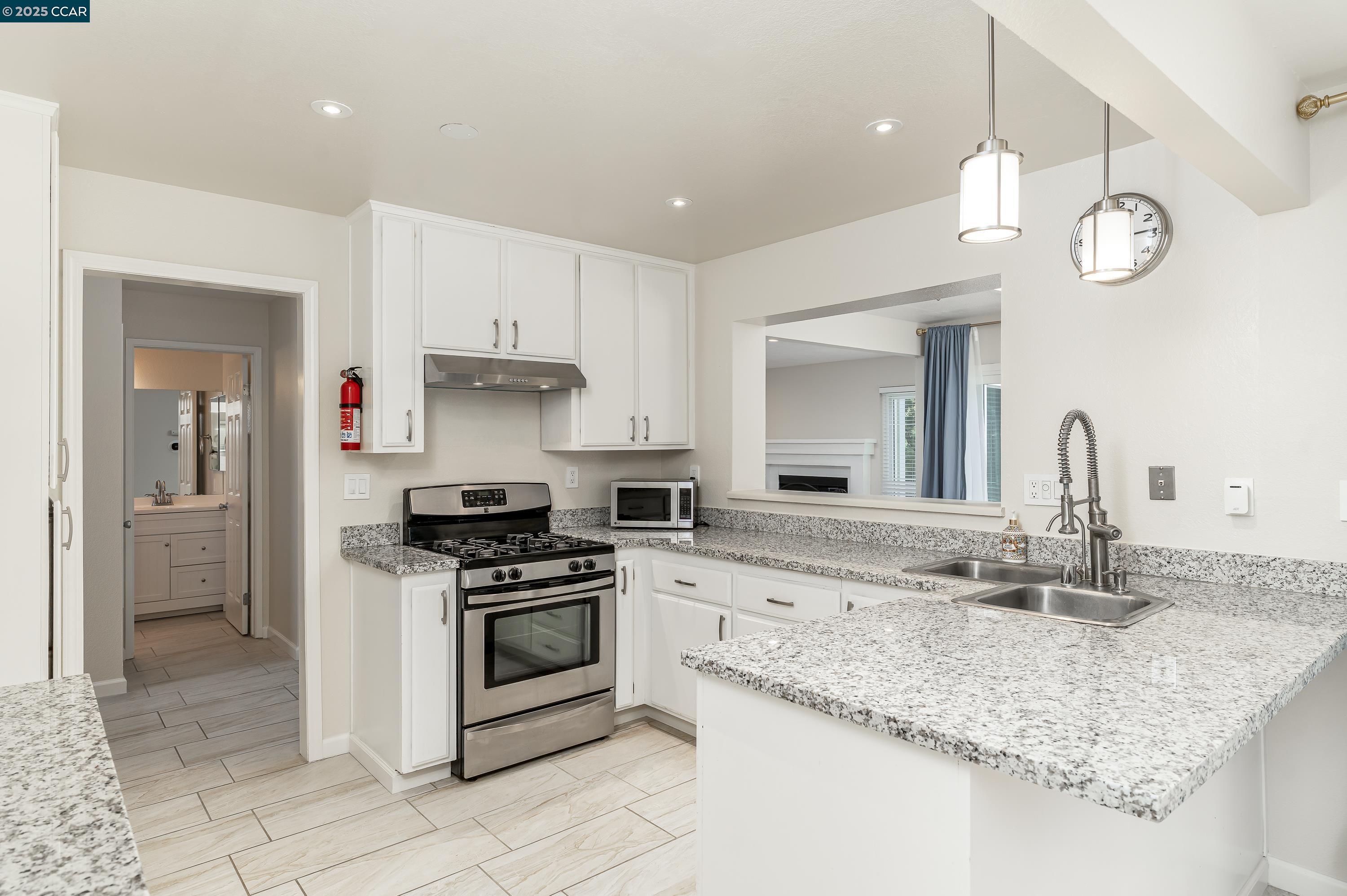 121 Brighton Street Hercules, CA 94547 - Photo 14 of 55 a kitchen with stainless steel appliances granite countertop a sink a stove and cabinets