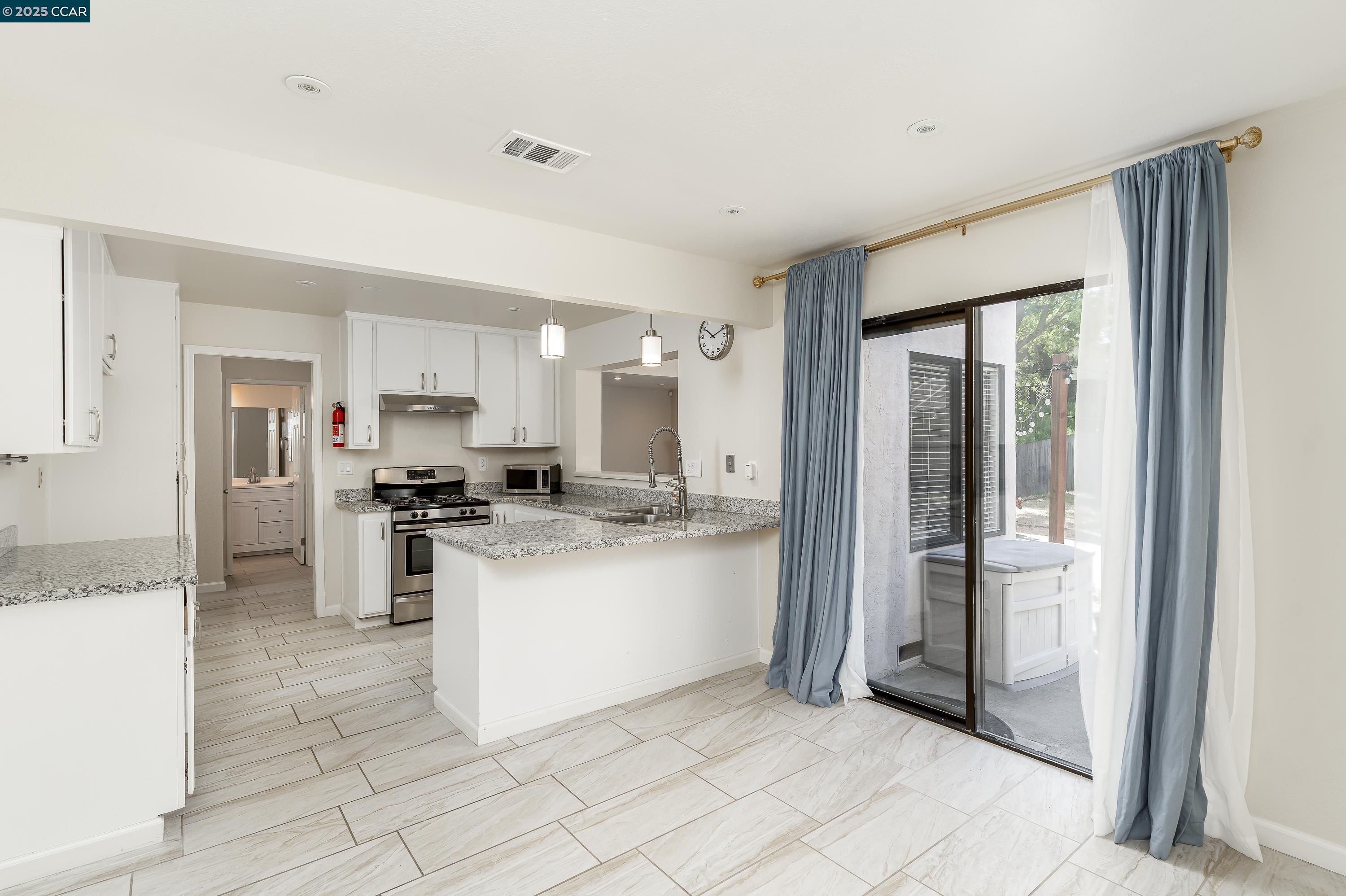 121 Brighton Street Hercules, CA 94547 - Photo 17 of 55 a kitchen with a refrigerator and a sink