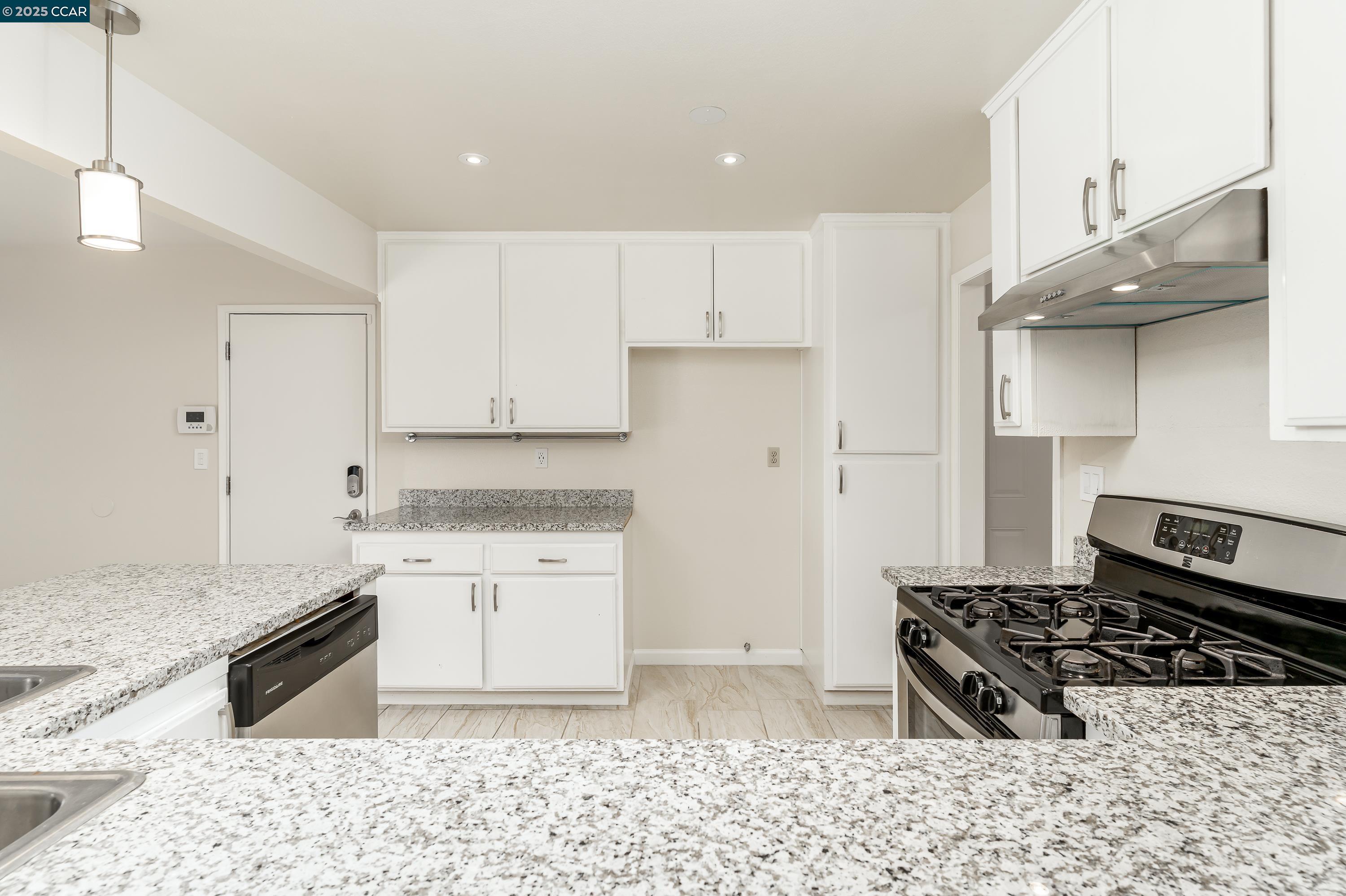 121 Brighton Street Hercules, CA 94547 - Photo 19 of 55 a kitchen with a stove a sink and a refrigerator