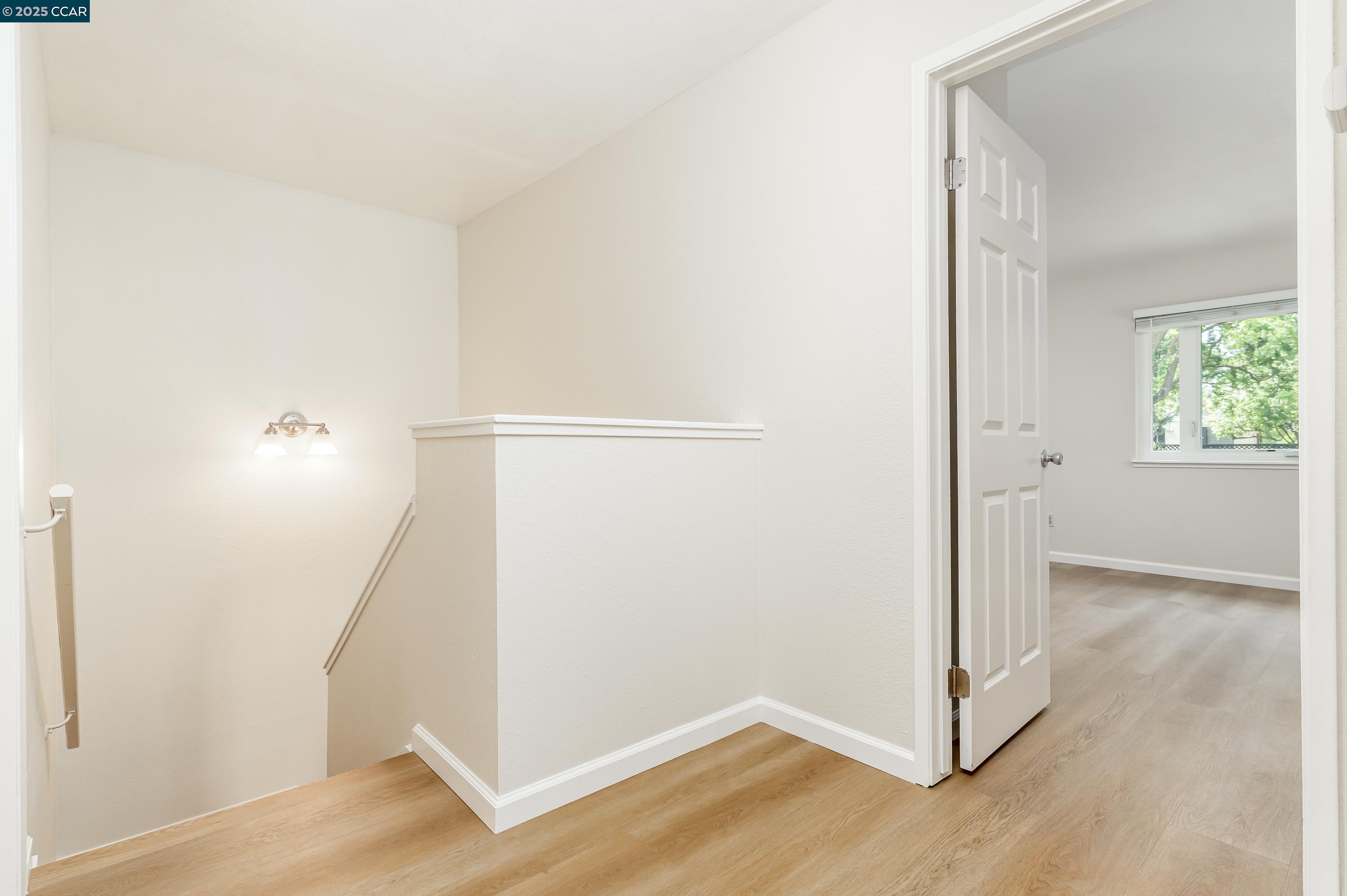 121 Brighton Street Hercules, CA 94547 - Photo 21 of 55 an empty room with wooden floor and windows