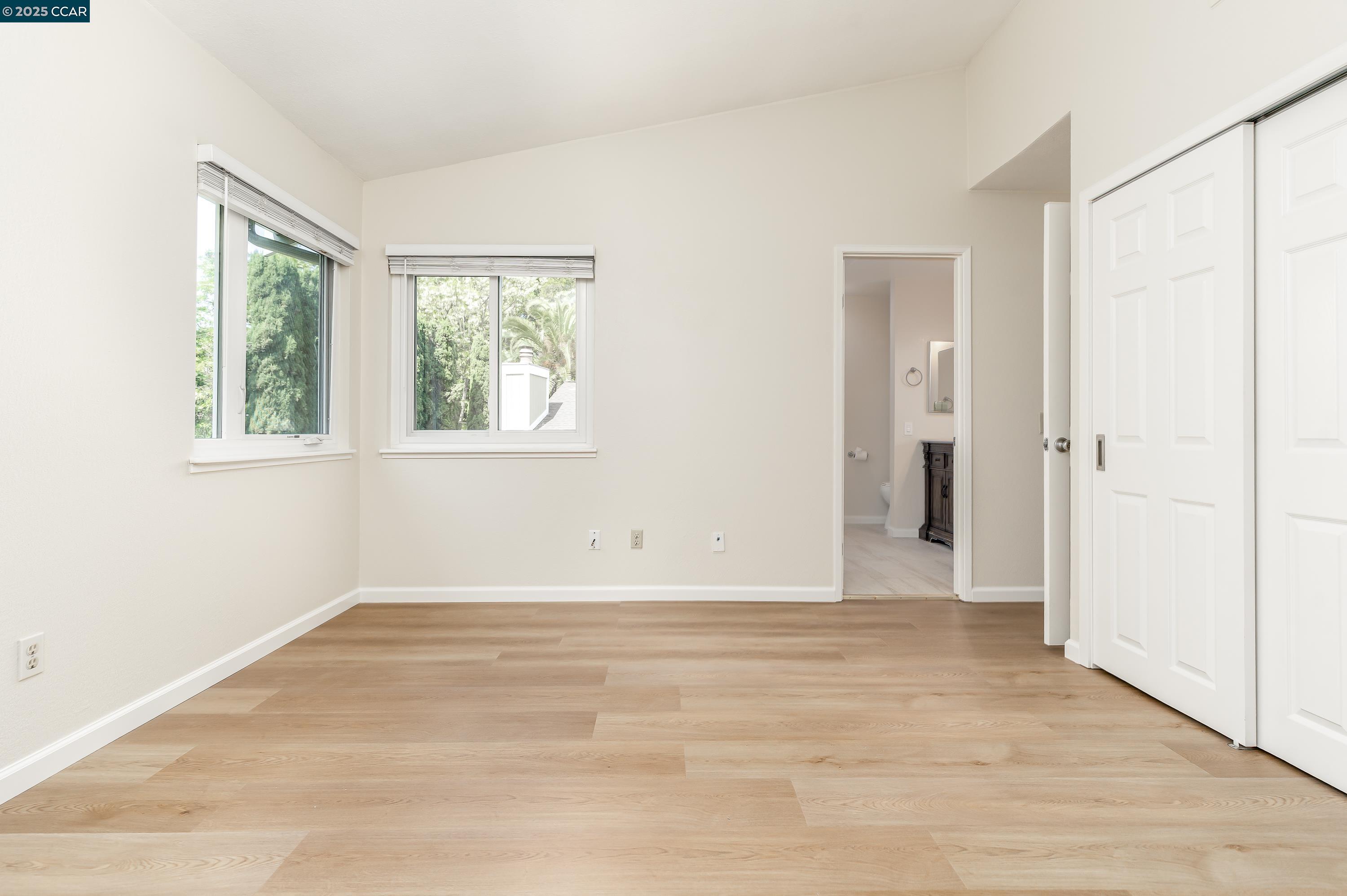 121 Brighton Street Hercules, CA 94547 - Photo 26 of 55 a view of an empty room with wooden floor and a window