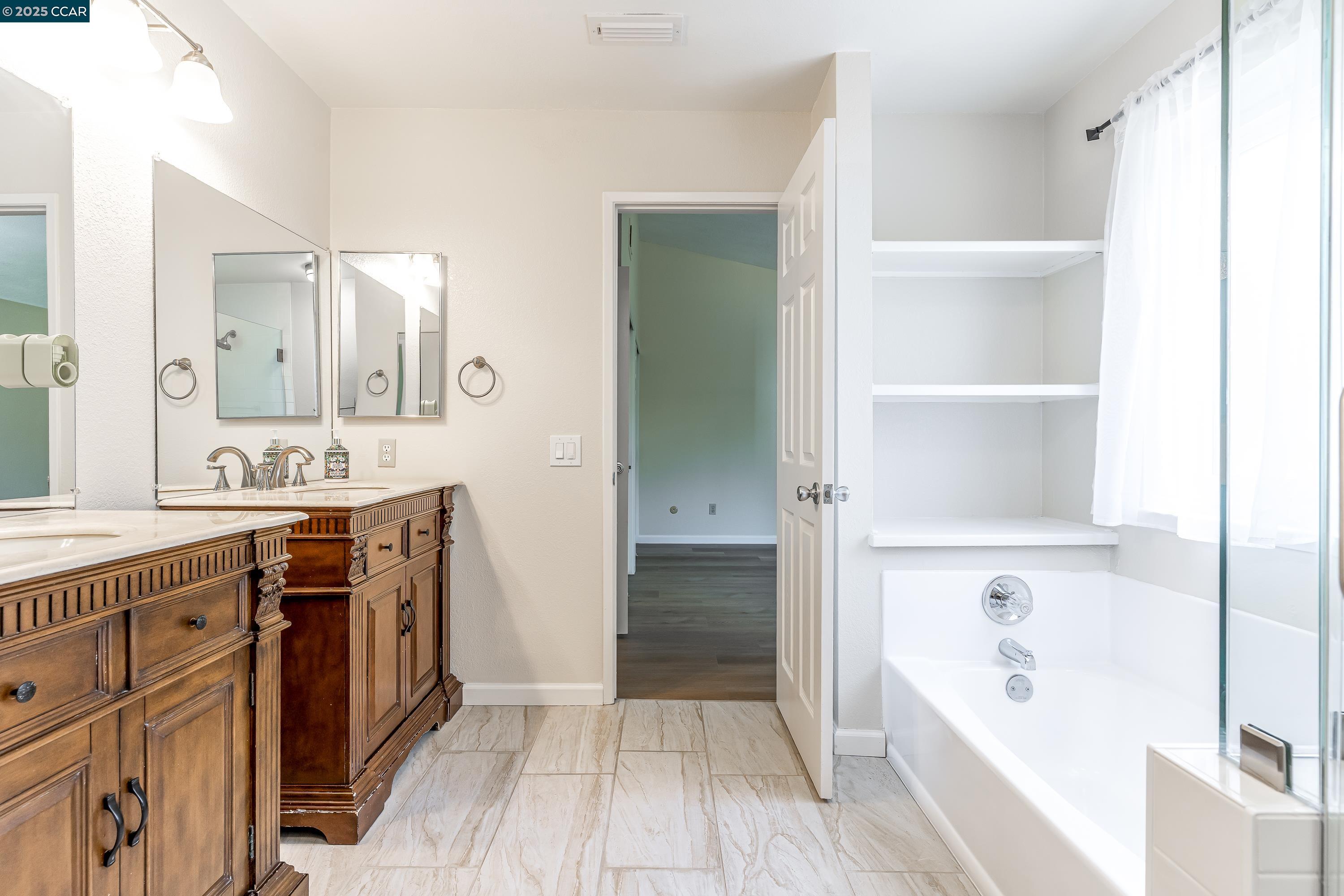 121 Brighton Street Hercules, CA 94547 - Photo 27 of 55 a spacious bathroom with a tub sink and mirror