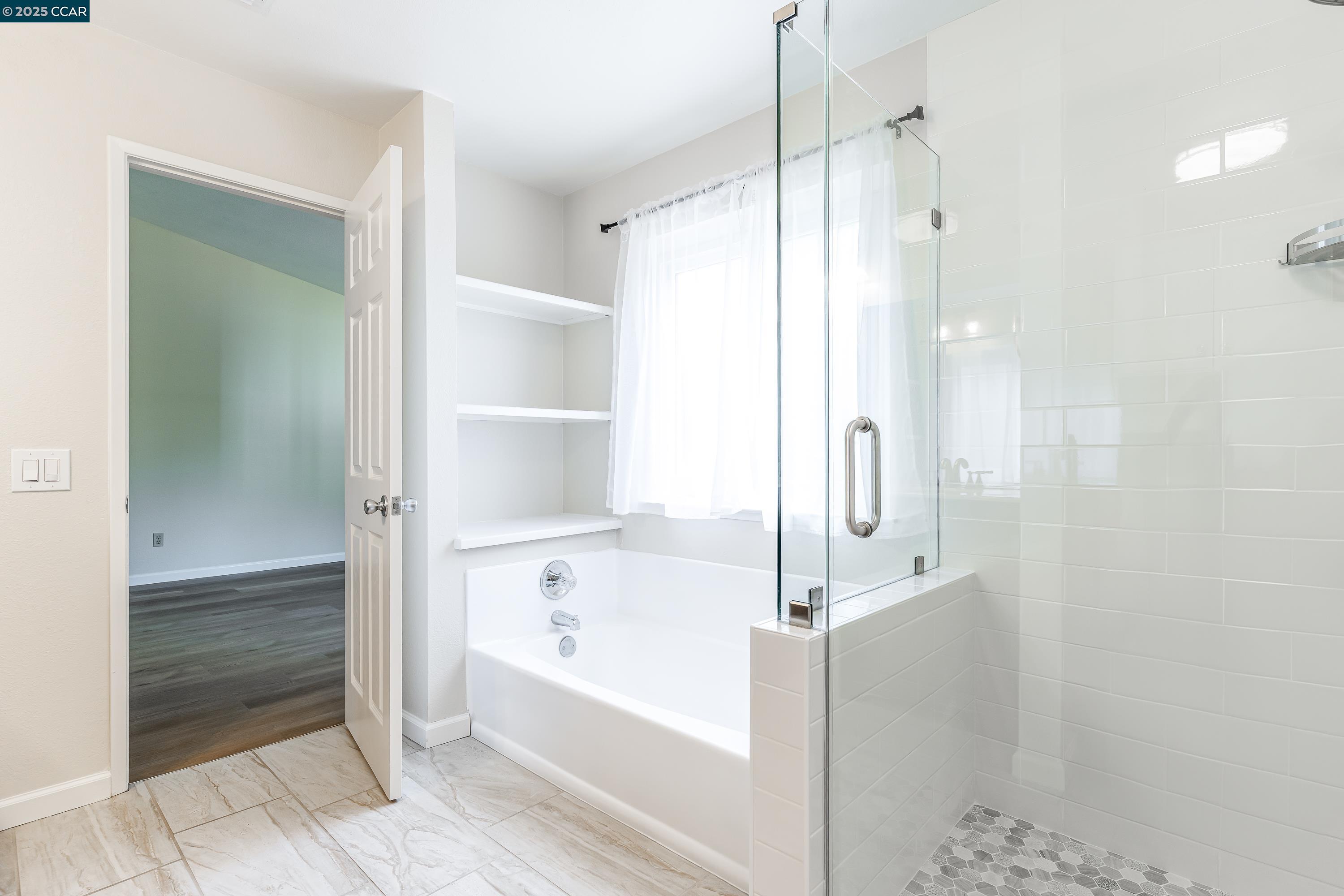 121 Brighton Street Hercules, CA 94547 - Photo 28 of 55 a bathroom with a bathtub and a shower