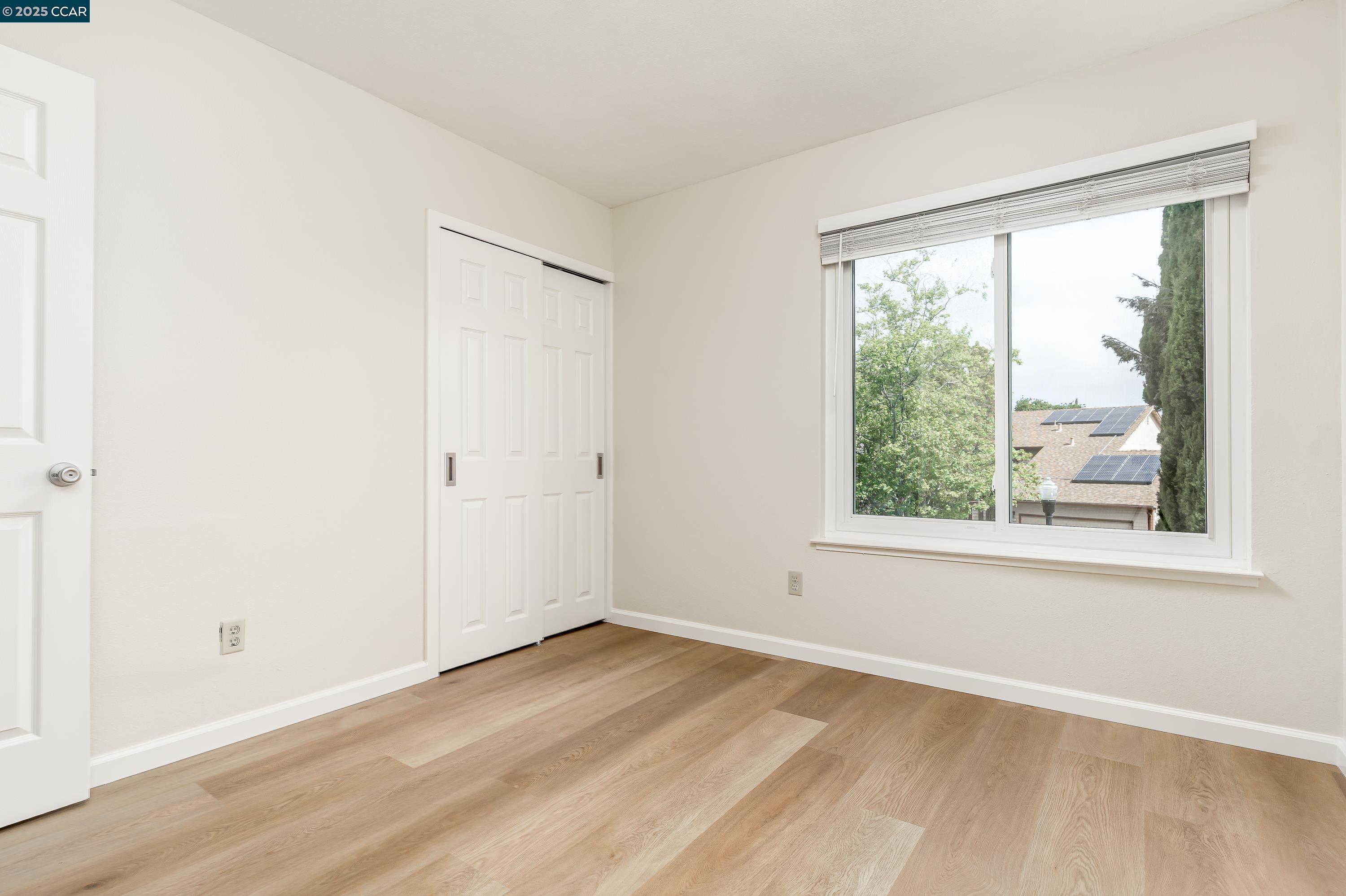 121 Brighton Street Hercules, CA 94547 - Photo 33 of 55 an empty room with wooden floor and windows