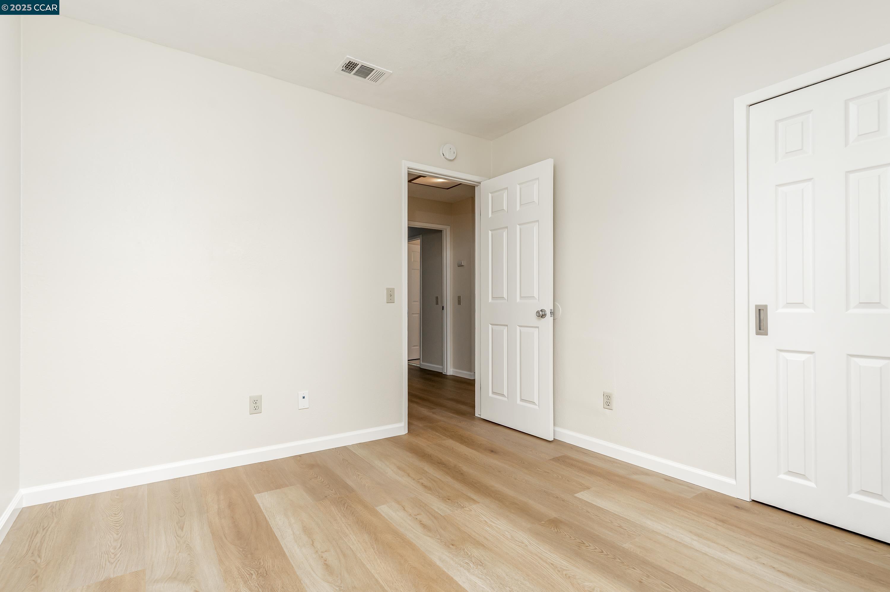 121 Brighton Street Hercules, CA 94547 - Photo 34 of 55 a view of an empty room with wooden floor