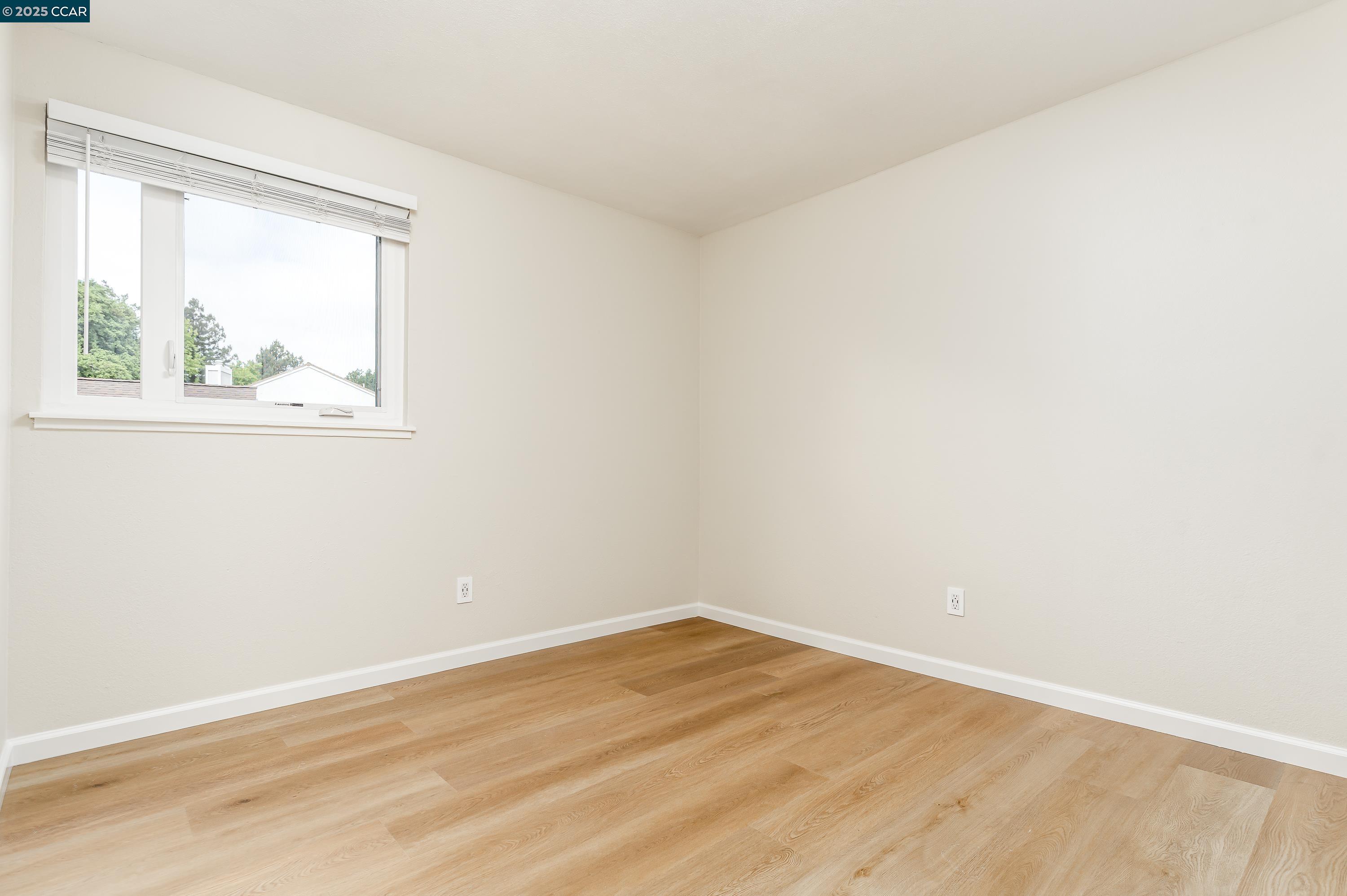 121 Brighton Street Hercules, CA 94547 - Photo 38 of 55 an empty room with wooden floor and windows