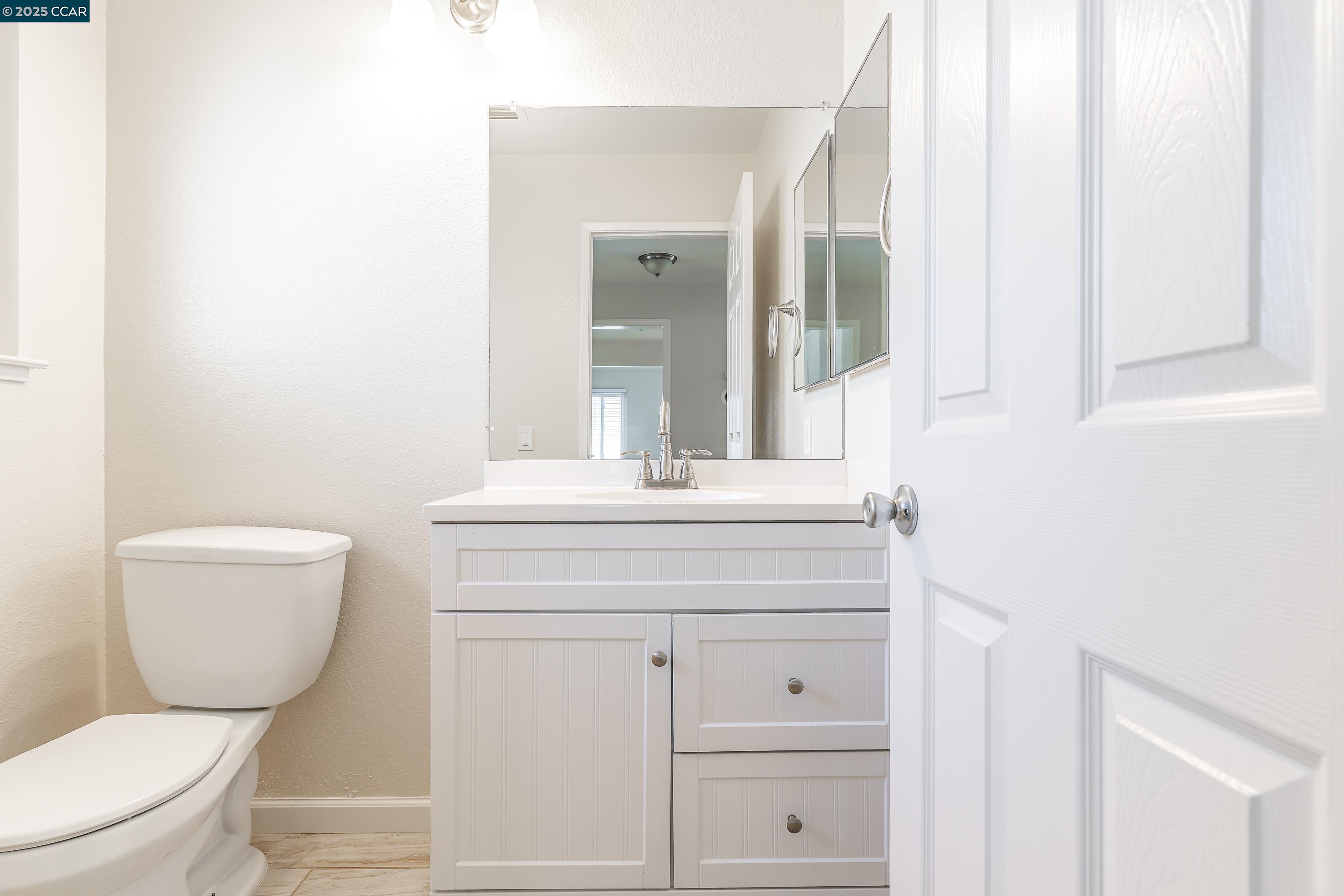 121 Brighton Street Hercules, CA 94547 - Photo 39 of 55 a bathroom with a toilet a sink and mirror