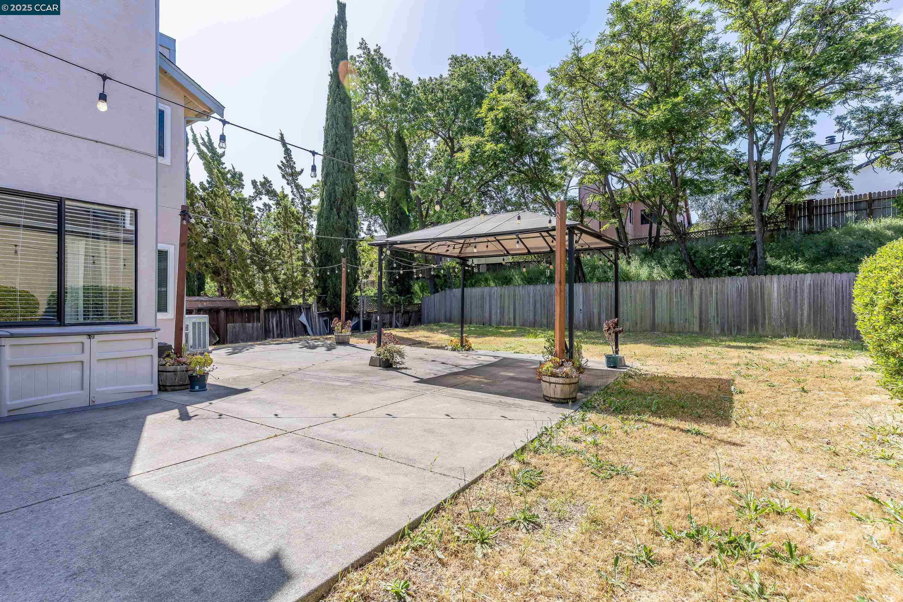 121 Brighton Street Hercules, CA 94547 - Photo 47 of 55 a view of a backyard with a garden and trees