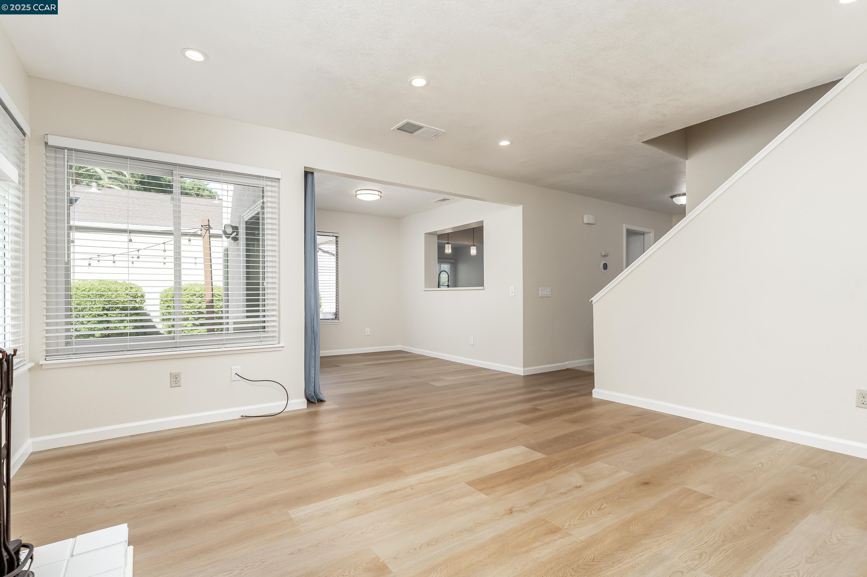 121 Brighton Street Hercules, CA 94547 - Photo 6 of 55 an empty room with wooden floor and windows