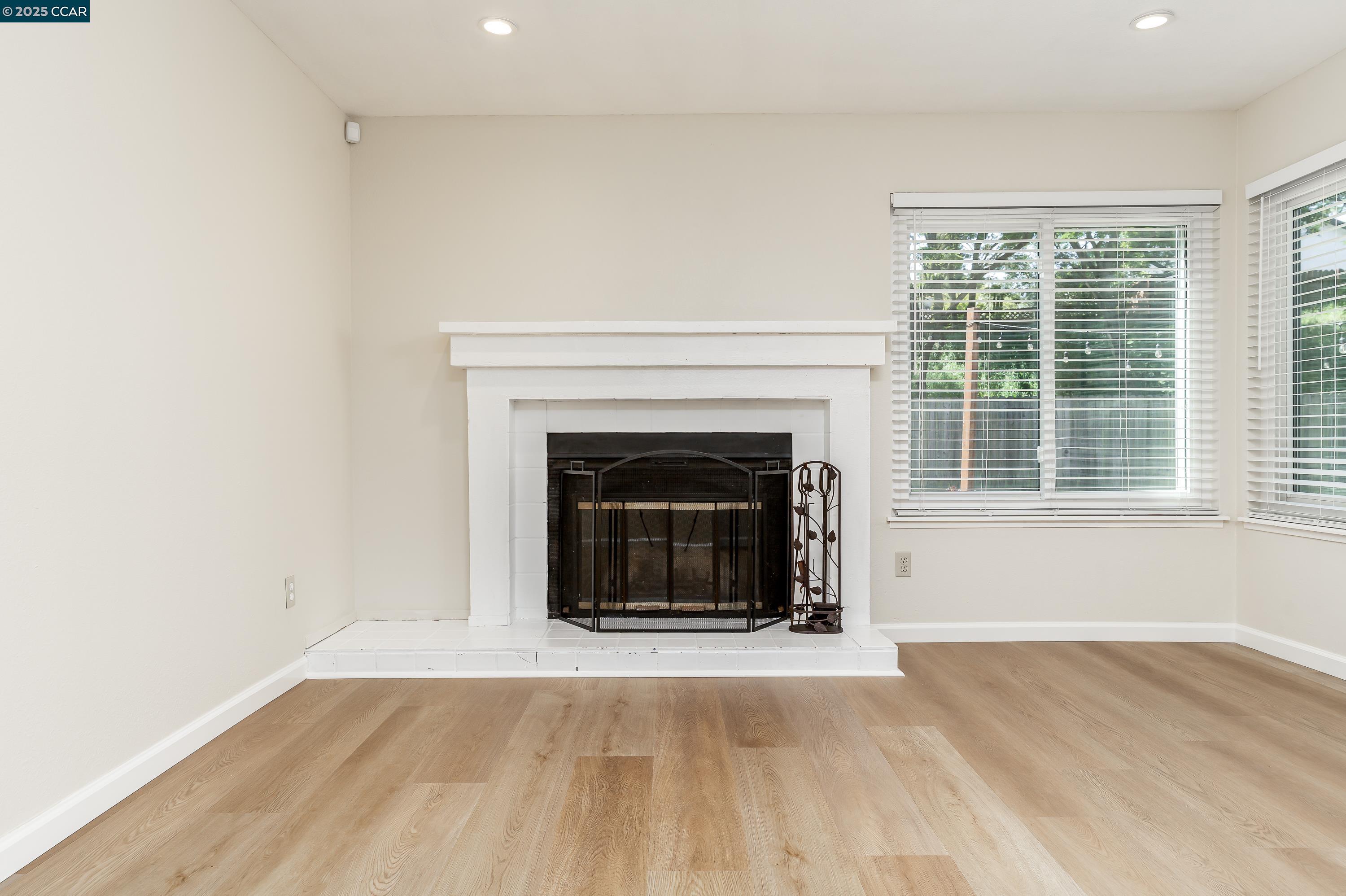 121 Brighton Street Hercules, CA 94547 - Photo 7 of 55 a living room with a fireplace and a floor to ceiling window