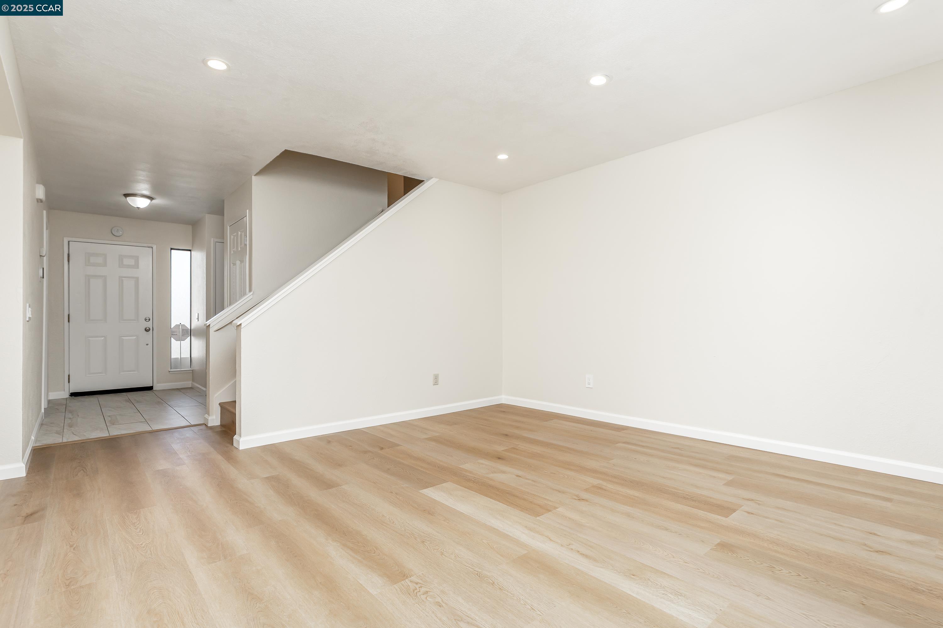 121 Brighton Street Hercules, CA 94547 - Photo 9 of 55 an empty room with wooden floor and windows