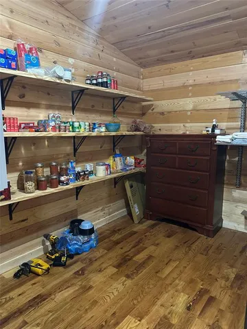 a view of a house with backyard and trees