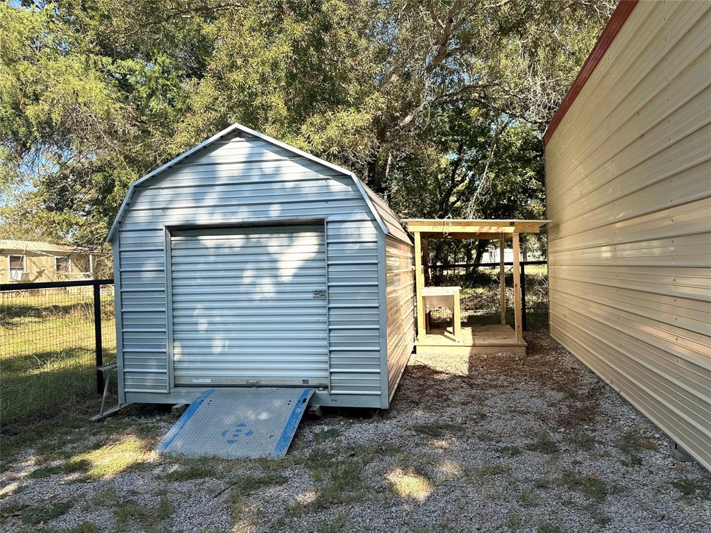 191 Cherry Lane Streetman, TX 75859 - Photo 23 of 40 a view of a small house with a yard and wooden fence