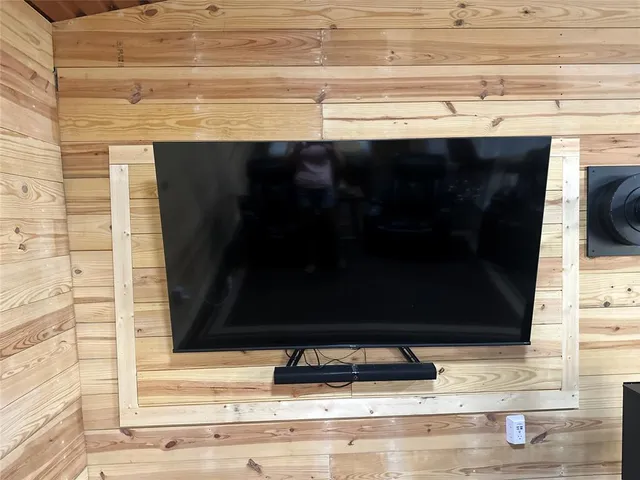 a kitchen with a refrigerator a stove cabinets and chairs