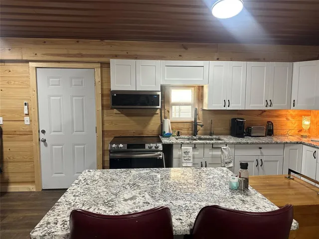 a outdoor kitchen with a stove and a table