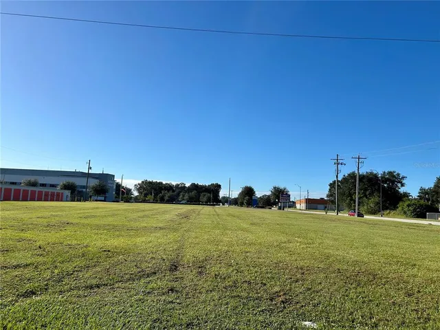 a view of a green field with clear sky