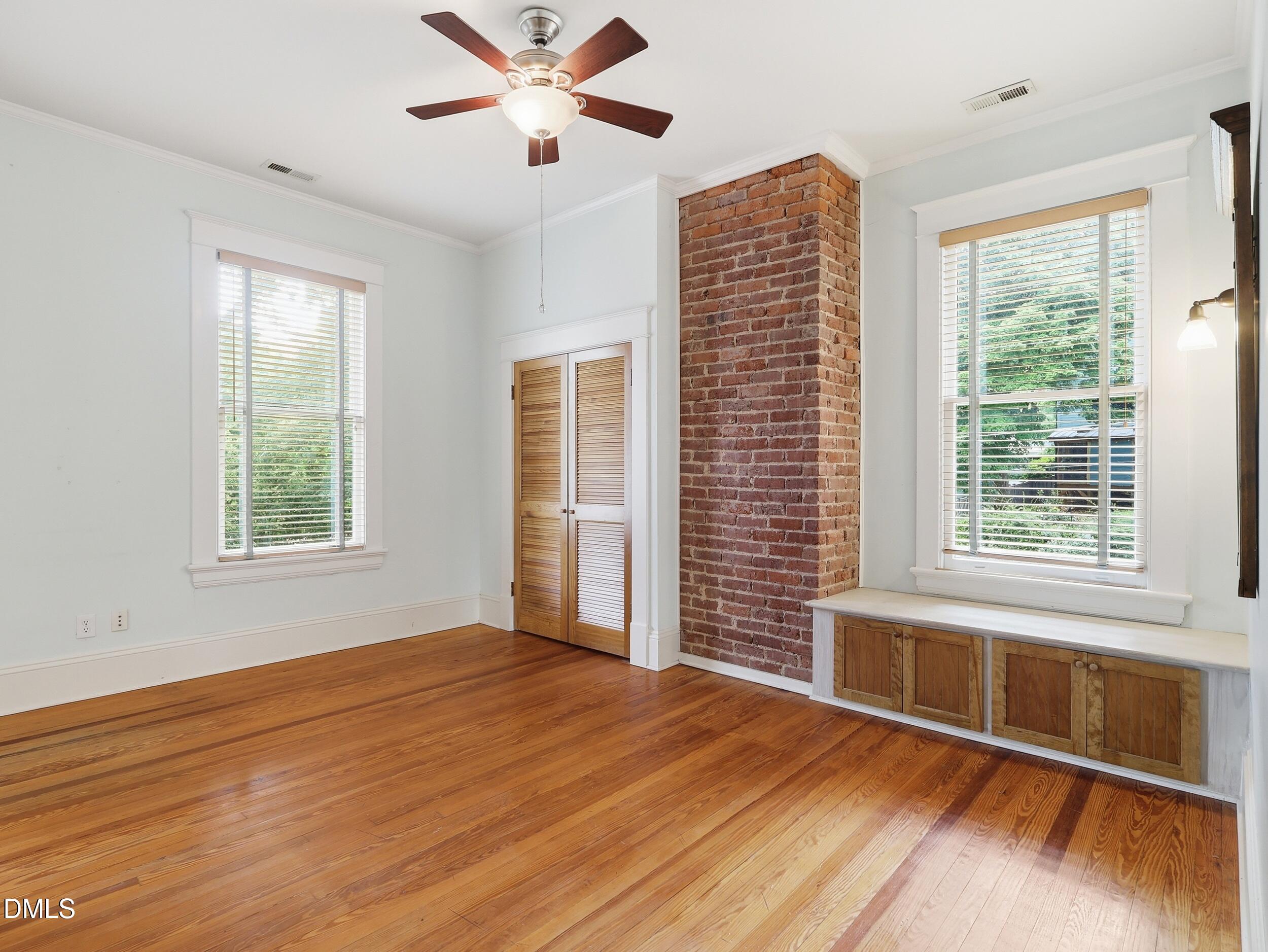 127 Forest Road Raleigh, NC 27605 - Photo 56 of 75 a view of an empty room with a window and wooden floor