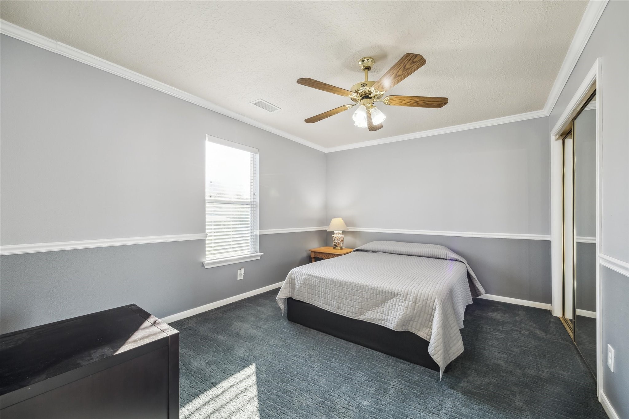7671 Ameswood Road Houston, TX 77095 - Photo 14 of 23 Spacious secondary bedroom on the upper floor. Two sliding door closets provide abundant storage. New carpet and pad installed in 2022. Crown molding, chair rail, and two toned paint make this room very attractive.