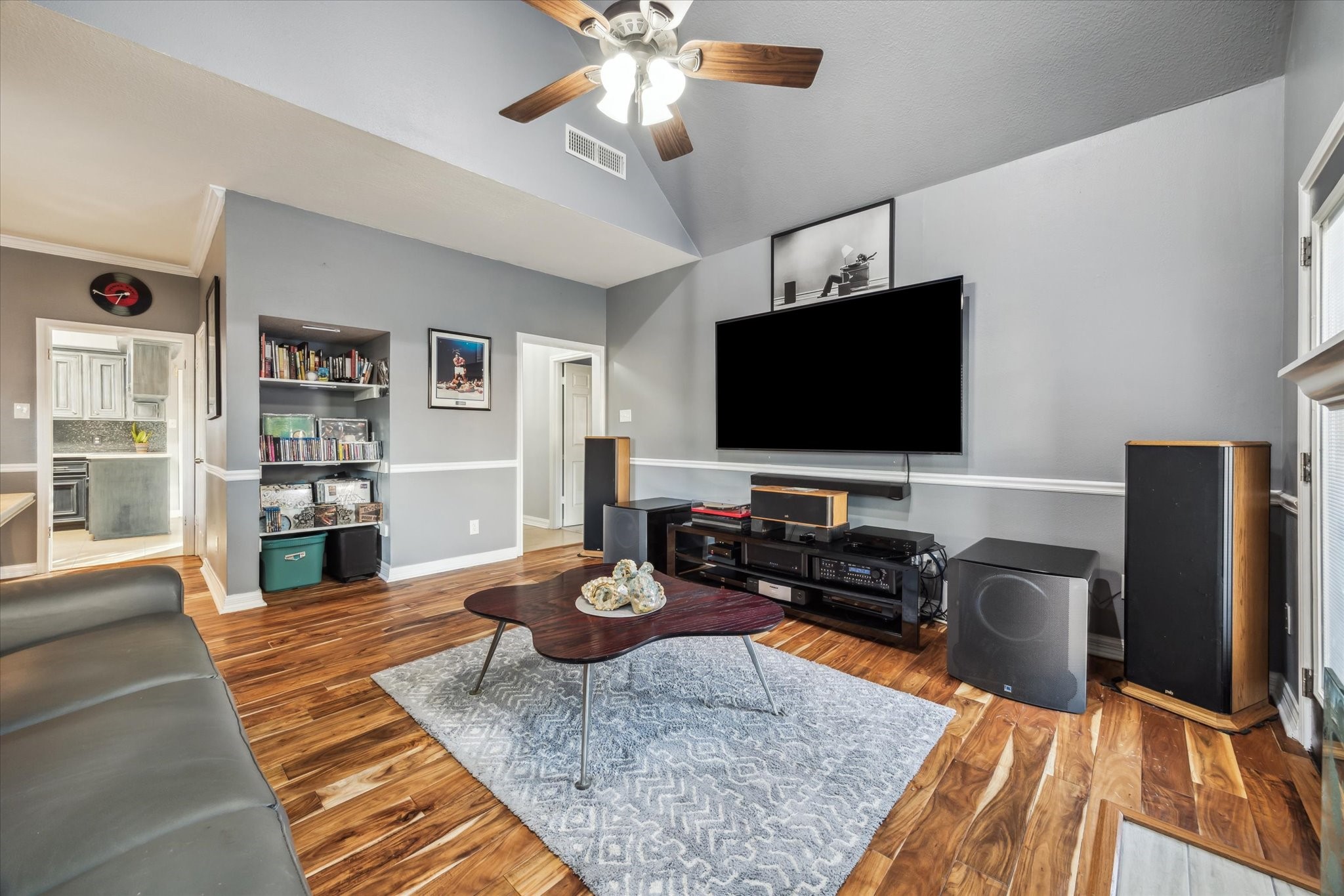 7671 Ameswood Road Houston, TX 77095 - Photo 5 of 23 The living room has been recently updated with paint, chair rail, a wood floors completed in 2022. To the left is the dining room and kitchen.