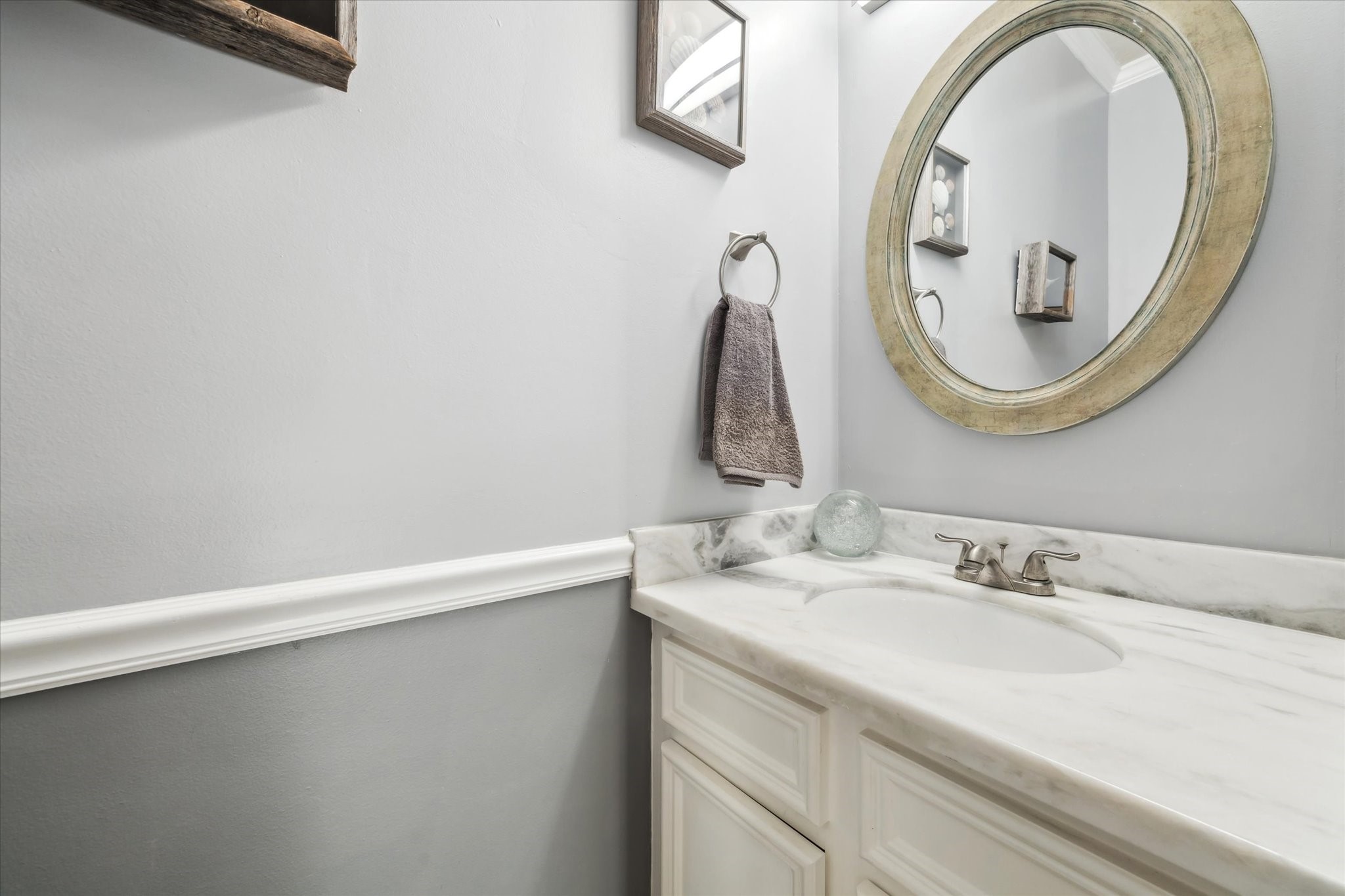7671 Ameswood Road Houston, TX 77095 - Photo 9 of 23 The guest powder bath is located on the first floor. Up to date finishes include paint, marble countertop, a new sink, and mirror which was all completed in 2022.
