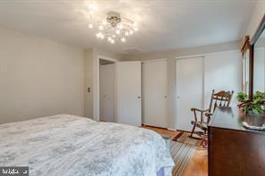 17 Devon Court Sterling, VA 20165 - Photo 20 of 30 a bedroom with a bed and a chandelier