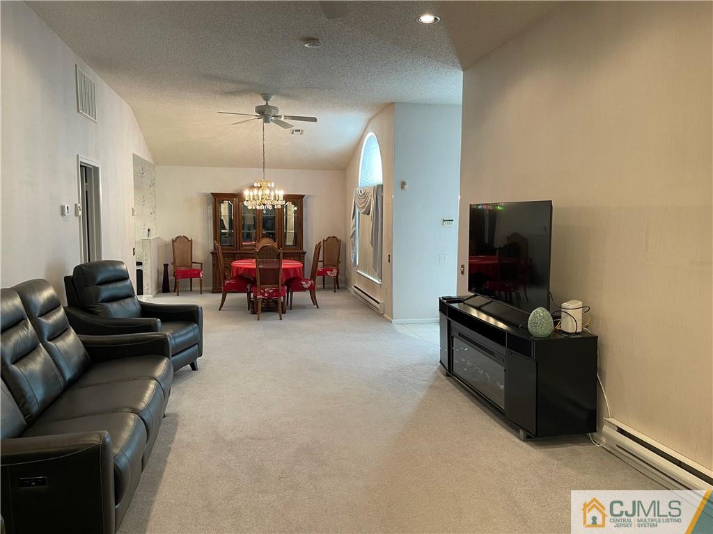 656 Nutley Drive, Unit A Monroe Township, NJ 08831 - Photo 11 of 25 a living room with furniture and a flat screen tv