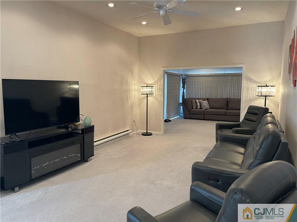 656 Nutley Drive, Unit A Monroe Township, NJ 08831 - Photo 12 of 25 a living room with furniture and a flat screen tv