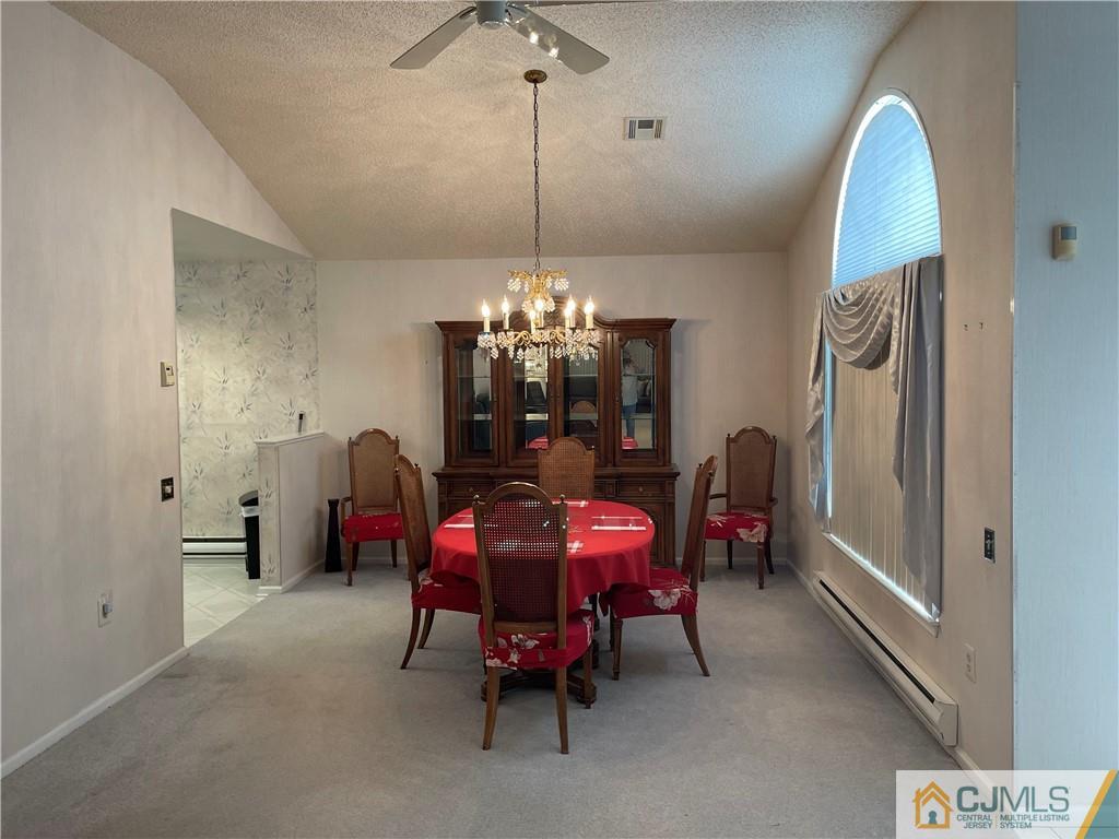 656 Nutley Drive, Unit A Monroe Township, NJ 08831 - Photo 13 of 25 a view of a dining room with furniture and chandelier