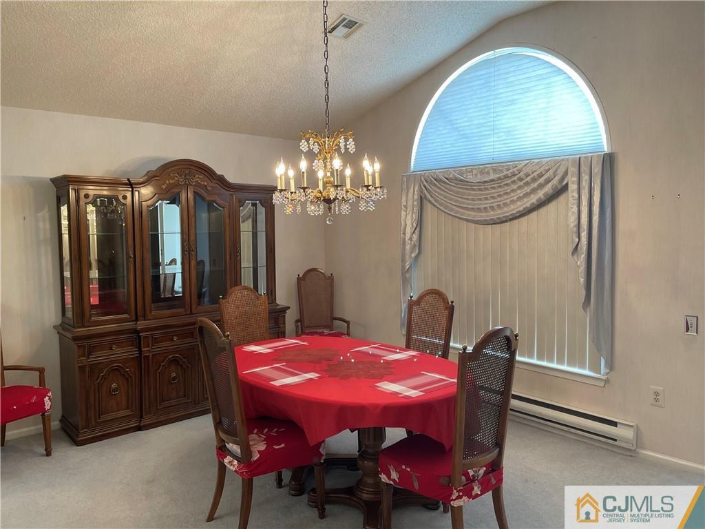 656 Nutley Drive, Unit A Monroe Township, NJ 08831 - Photo 14 of 25 a view of a dining room with furniture and chandelier