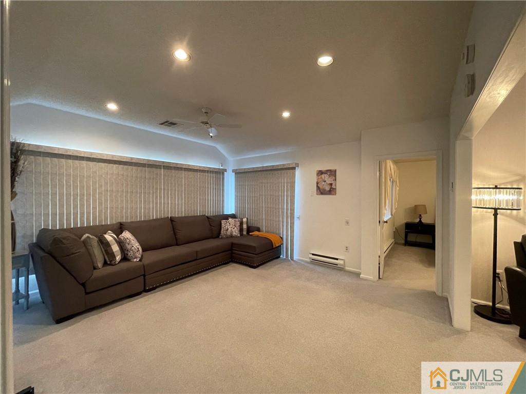 656 Nutley Drive, Unit A Monroe Township, NJ 08831 - Photo 17 of 25 a living room with furniture and a flat screen tv