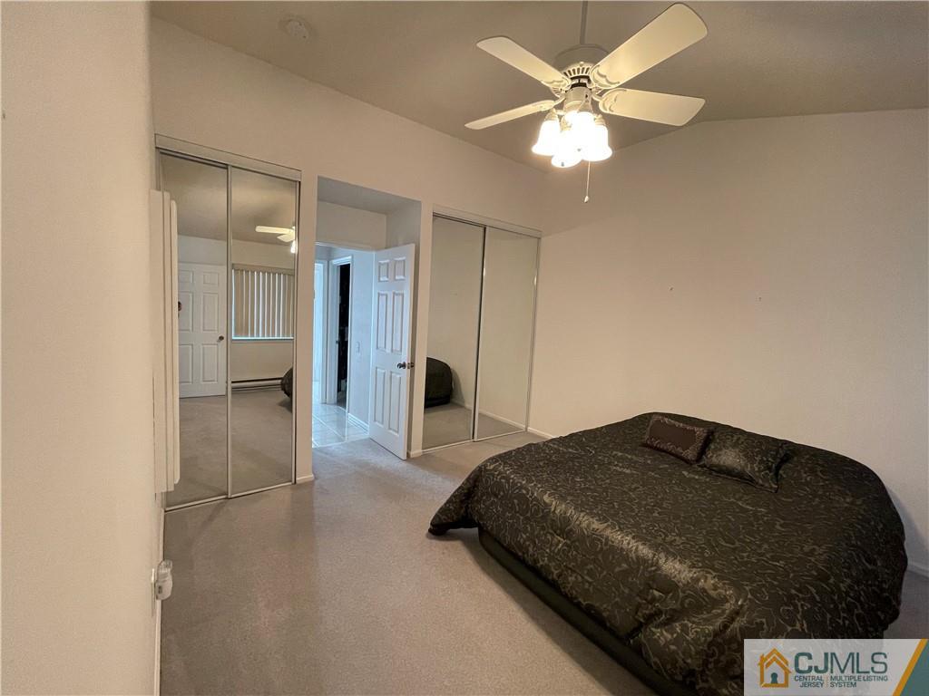 656 Nutley Drive, Unit A Monroe Township, NJ 08831 - Photo 24 of 25 a bedroom with a bed and a chandelier