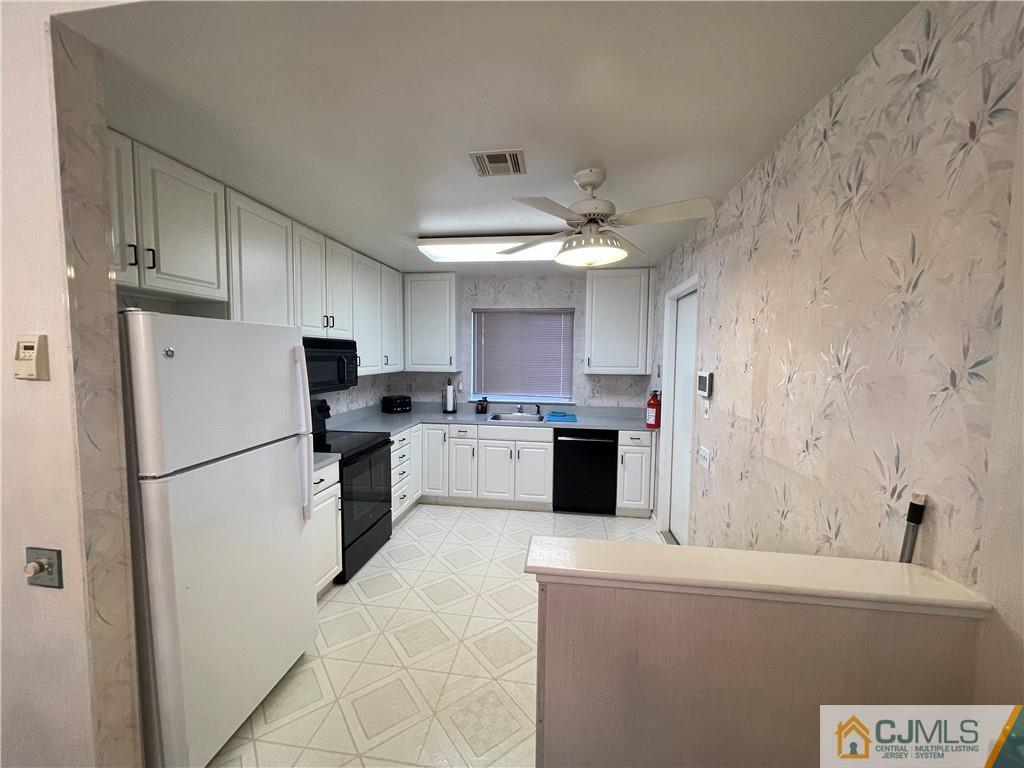 656 Nutley Drive, Unit A Monroe Township, NJ 08831 - Photo 6 of 25 a kitchen with a sink a refrigerator and a stove