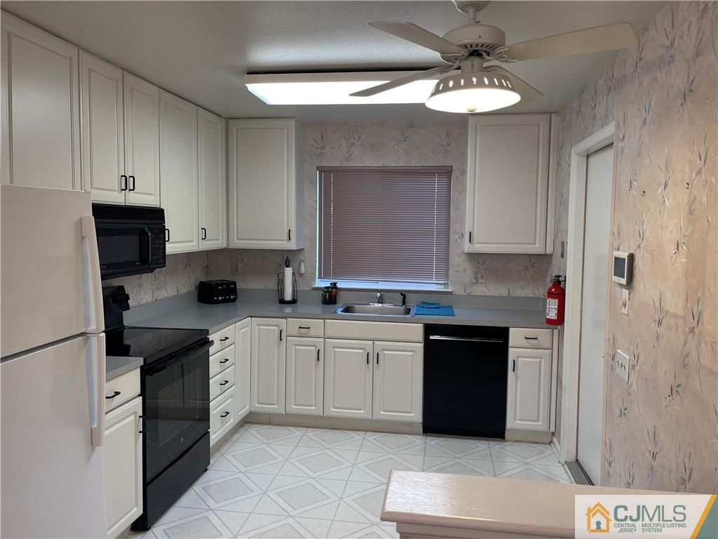 656 Nutley Drive, Unit A Monroe Township, NJ 08831 - Photo 7 of 25 a kitchen with a sink and cabinets