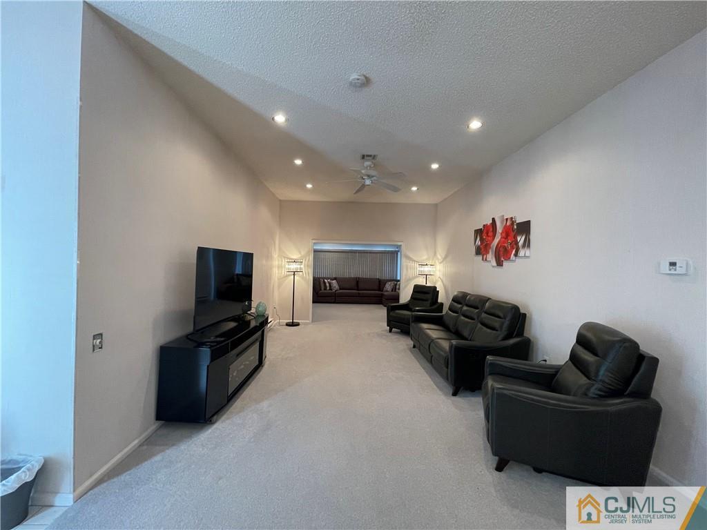 656 Nutley Drive, Unit A Monroe Township, NJ 08831 - Photo 10 of 25 a living room with furniture and a flat screen tv