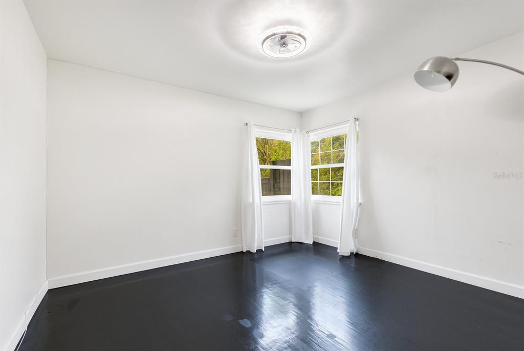 344 Starling Road Winter Park, FL 32789 - Photo 25 of 43 an empty room with wooden floor and windows