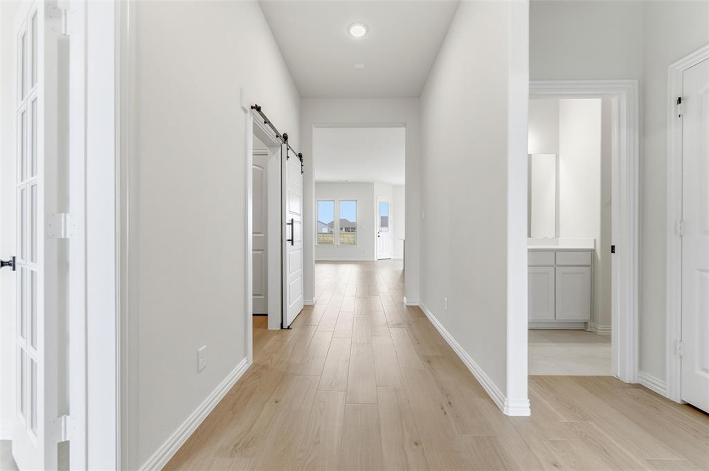 114 Brandywine Trail Rhome, TX 76078 - Photo 6 of 27 a view of a hallway with wooden floor