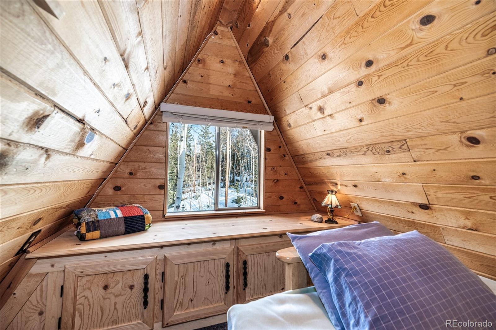 340 Wampum Lane Como, CO 80456 - Photo 15 of 35 a bedroom with a bed and a large window